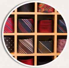 Närbild på hoprullade slipsar i en hylla med fyrkantiga fack.